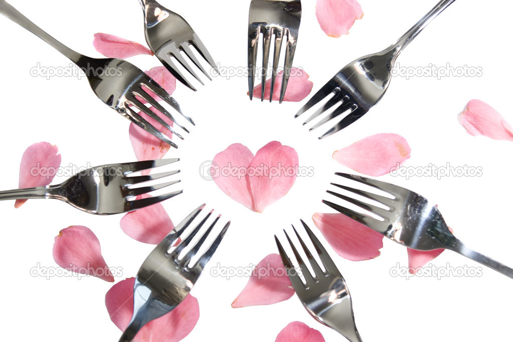 forks surrounding heart shape with rose petals