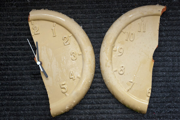 broken frozen clock face on black mat