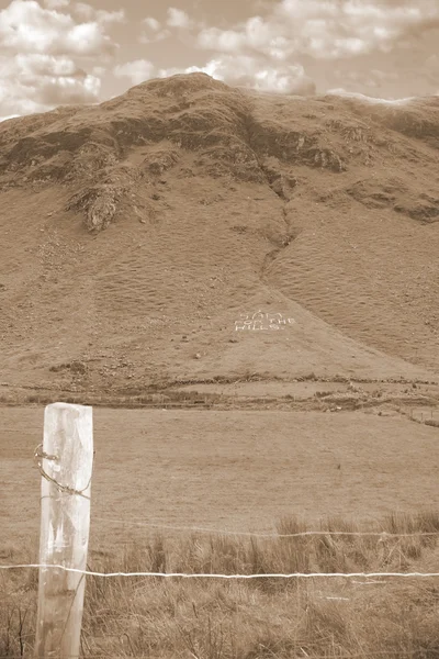 Sam for the hills written with rocks in sepia — Stock Photo, Image