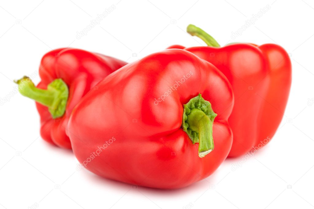 Three red sweet peppers