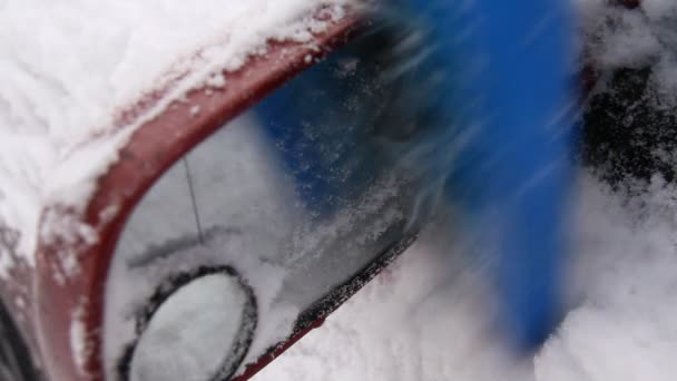 Man reinigt een auto van de sneeuw — Stockvideo