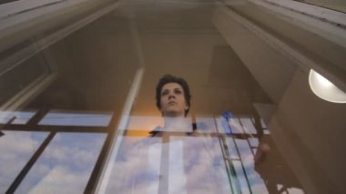 kadın pencereyi temizliyor