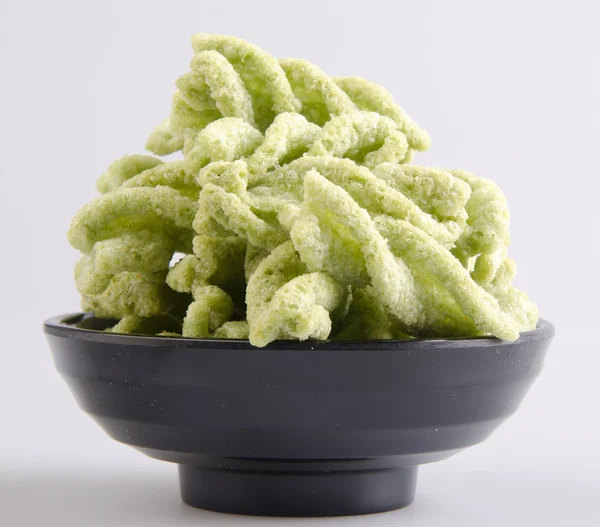 Comida chatarra, aperitivo de guisantes verdes sobre un fondo — Foto de Stock