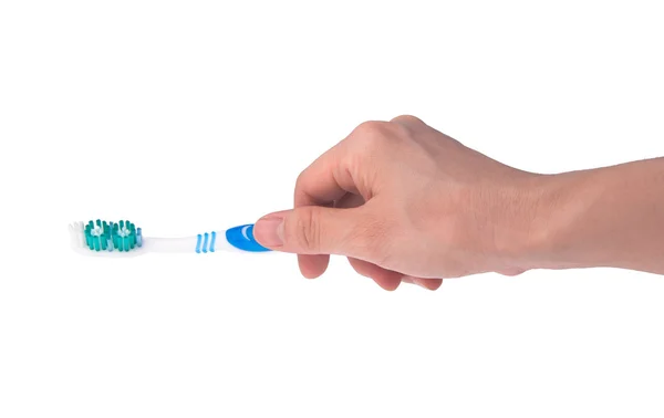Toothbrush in hand on background. — Stock Photo, Image