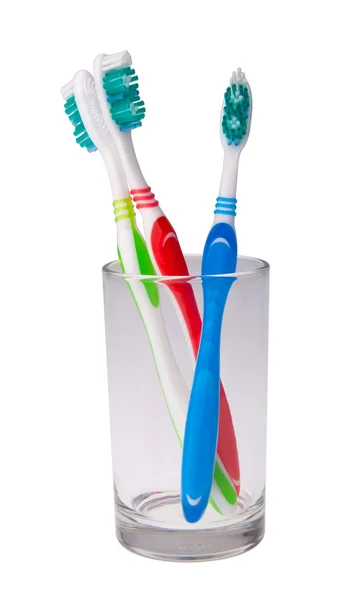 Colorful toothbrushes in a glass on background. — Stock Photo, Image