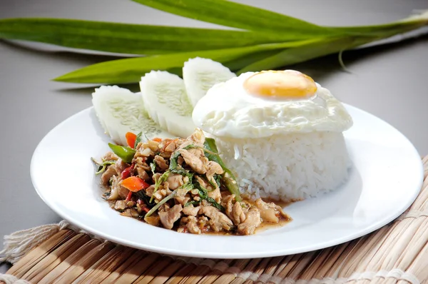 Chicken with rice and vegetables in background — Stock Photo, Image