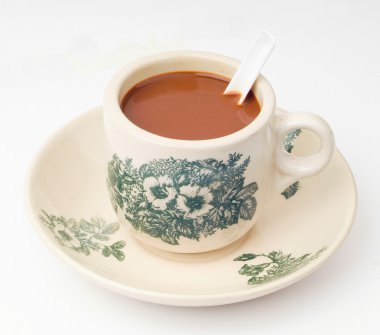 Arka planda bir fincan kahve.