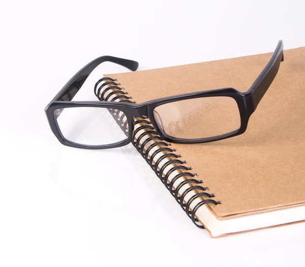Anteojos. gafas de ojo con libro en el fondo —  Fotos de Stock
