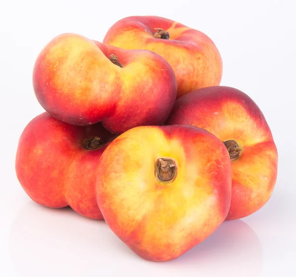 Flat peaches (donut peaches) on a background — Stock Photo, Image