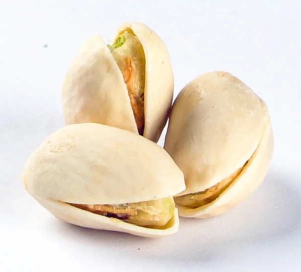 Noten. pimpernoten (pistaches) op de achtergrond — Stockfoto