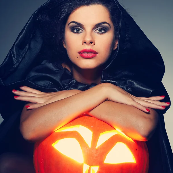 Sexual brunette in the suit of witch in night of Halloween Stock Picture