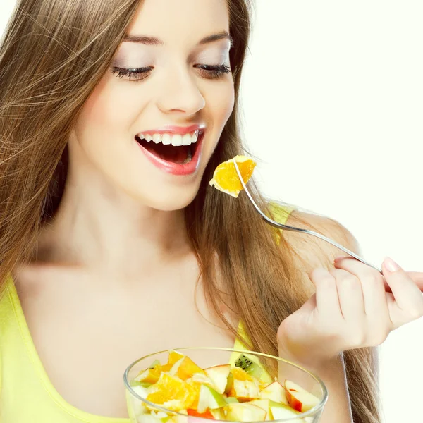 Portrait of a pretty young woman eating fruit salad — Stock Photo, Image