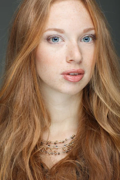 Closeup portrait of sexy redheaded young woman with beautiful blue eyes on white background — Stock Photo, Image