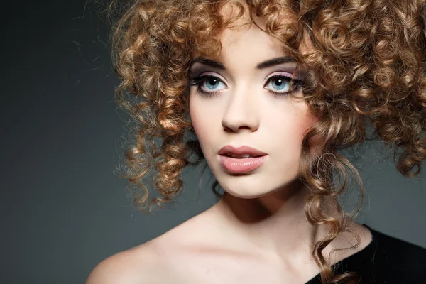 Young beautiful woman with long curly hairs — Stock Photo, Image