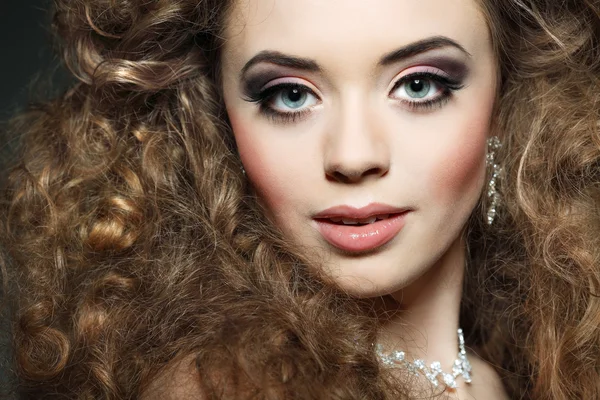 Young beautiful woman with long curly hairs — Stock Photo, Image