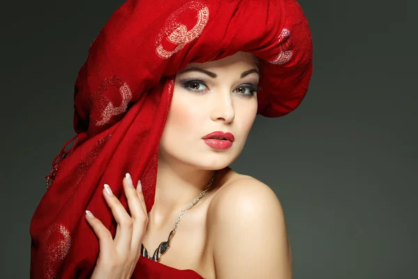 Beautiful girl in the red fabric — Stock Photo, Image