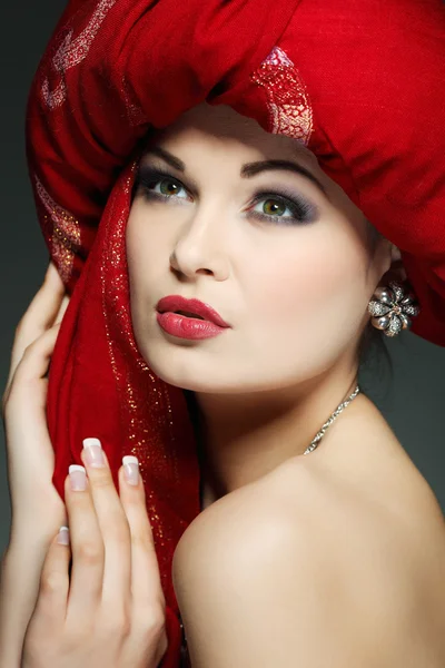 Beautiful girl in the red fabric — Stock Photo, Image