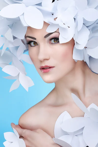 Wonderful girl in a hat from paper white butterflies. On a blue background. Beauty Face — Stock Photo, Image