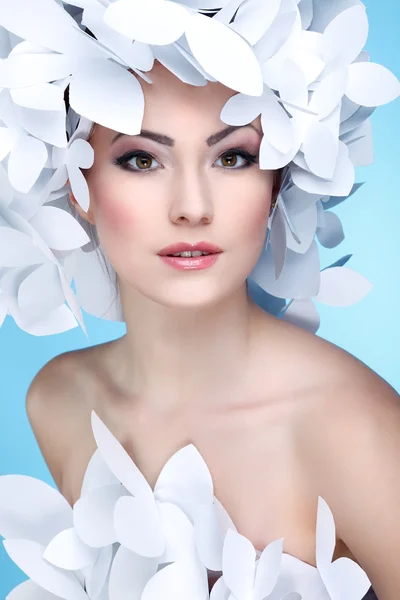 Wonderful girl in a hat from paper white butterflies. On a blue background. Beauty Face — Stock Photo, Image