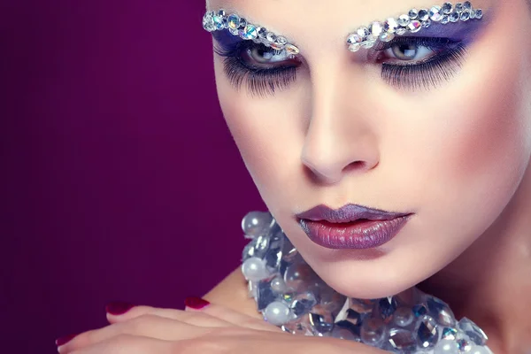 Portrait of sexual beautiful girl with strasses on face, on a violet background — Stock Photo, Image