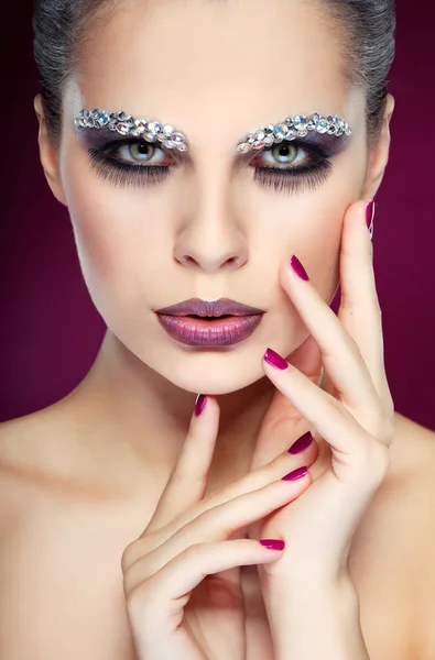 Portrait of sexual beautiful girl with strasses on face, on a violet background — Stock Photo, Image