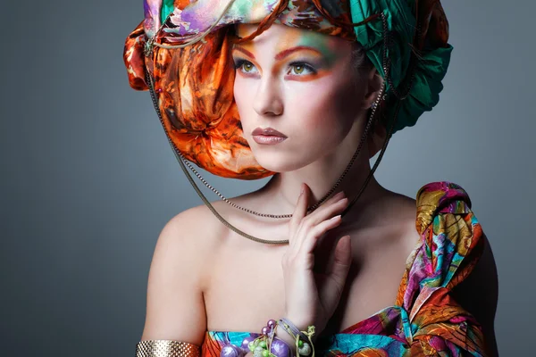 A photo of beautiful redheaded girl in a head-dress from the coloured fabric, glamour — Stock Photo, Image