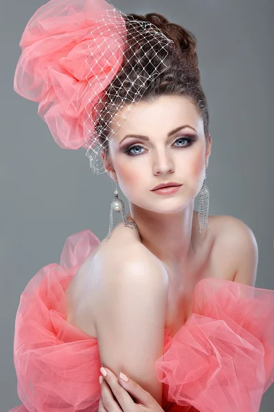 Portrait of beautiful girl with a hat from a pink veil — Stock Photo, Image