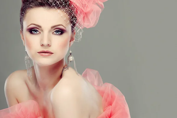 Portrait of beautiful girl with a hat from a pink veil — Stock Photo, Image