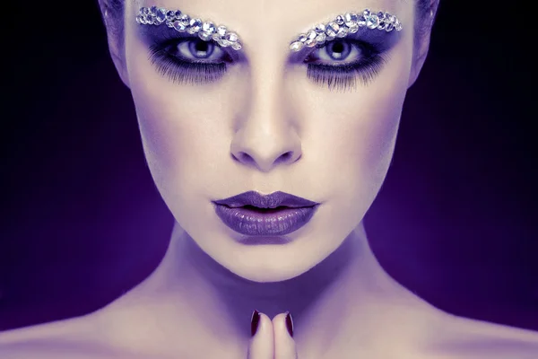 Portrait of sexual beautiful girl with strasses on face, on a violet background — Stock Photo, Image