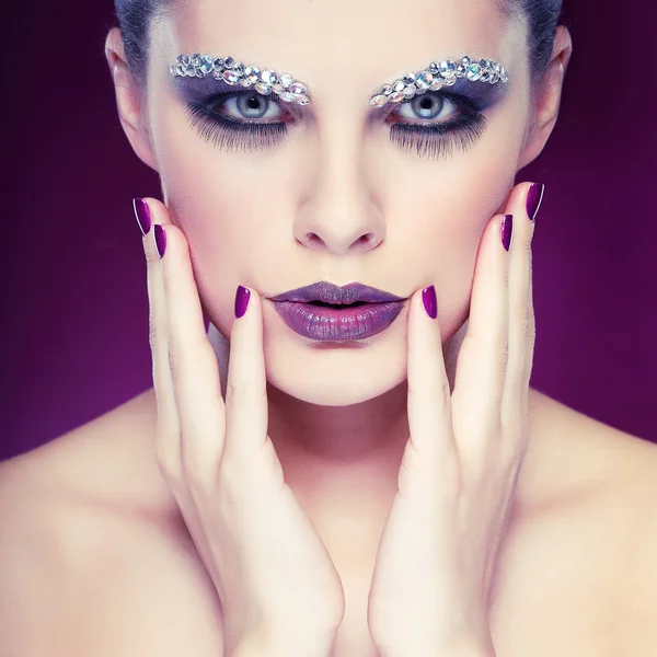 Portrait of sexual beautiful girl with strasses on face, on a violet background — Stock Photo, Image