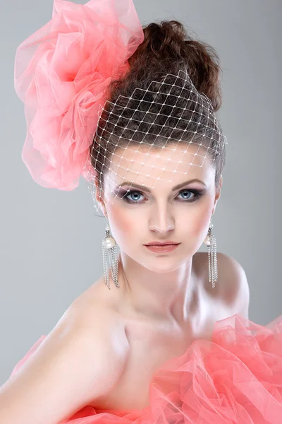 Portrait of beautiful girl with a hat from a pink veil — Stock Photo, Image