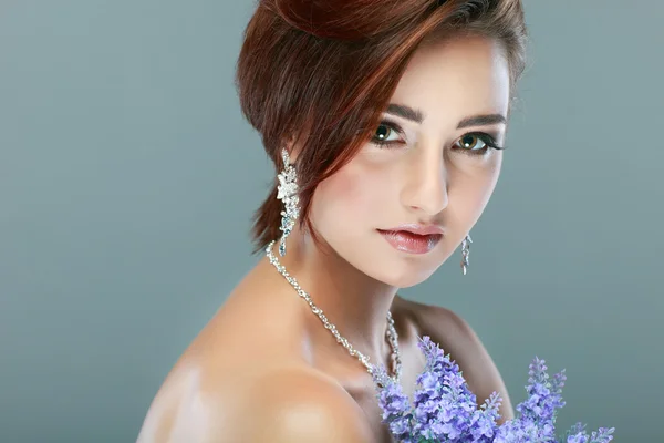 Close-up retrato de bela jovem com flores violetas — Fotografia de Stock