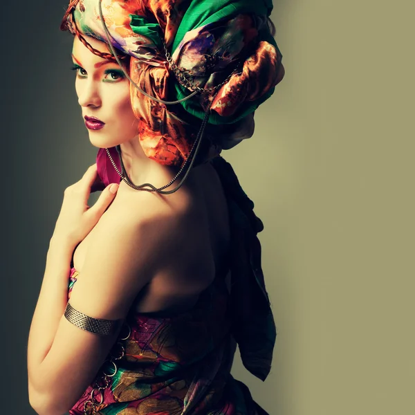 A photo of beautiful redheaded girl in a head-dress from the coloured fabric, glamour — Stock Photo, Image