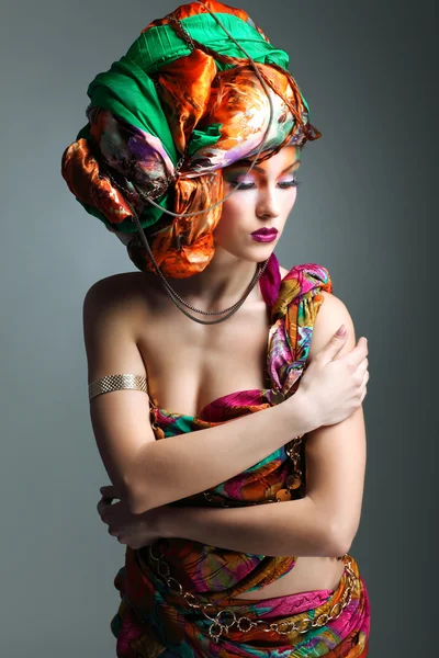 A photo of beautiful redheaded girl in a head-dress from the coloured fabric, glamour — Stock Photo, Image