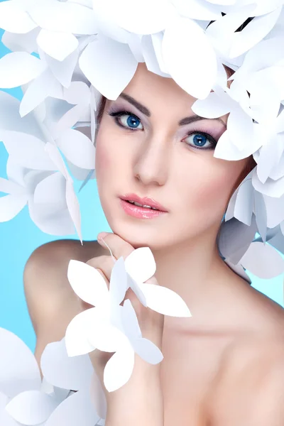 Wonderful girl in a hat from paper white butterflies. On a blue background. Beauty Face — Stock Photo, Image