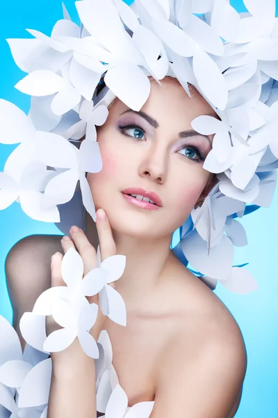 Wonderful girl in a hat from paper white butterflies. On a blue background. Beauty Face — Stock Photo, Image