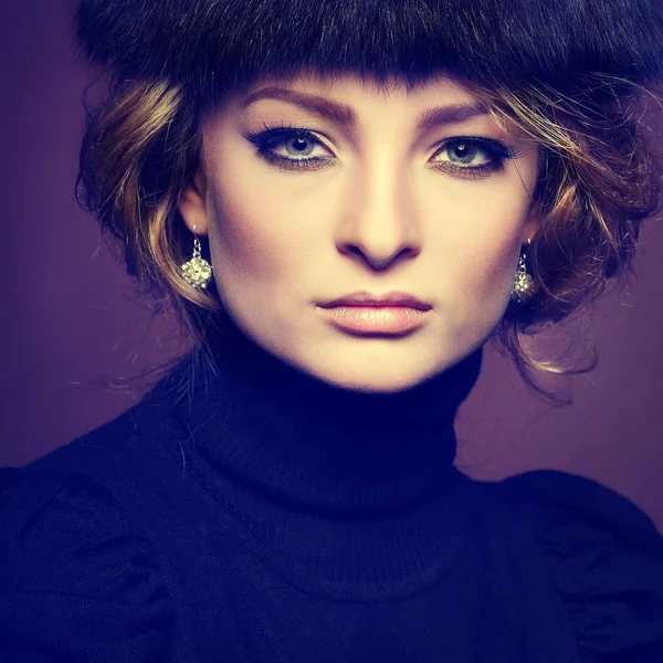 Ritratto di giovane donna elegante in un maglione nero su sfondo marrone — Foto Stock