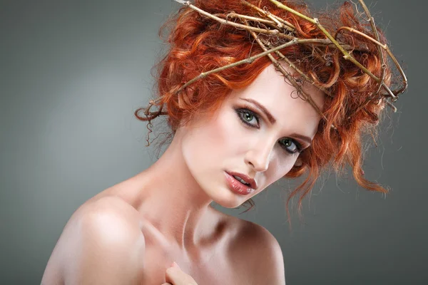 Red hairs. Portrait of beautiful girl in a chaplet from branches. — Stock Photo, Image