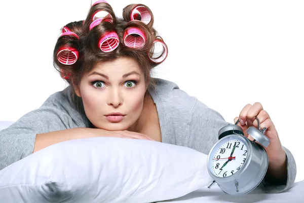 Happy positive young woman waking up and switching off the alarm clock — Stock Photo, Image