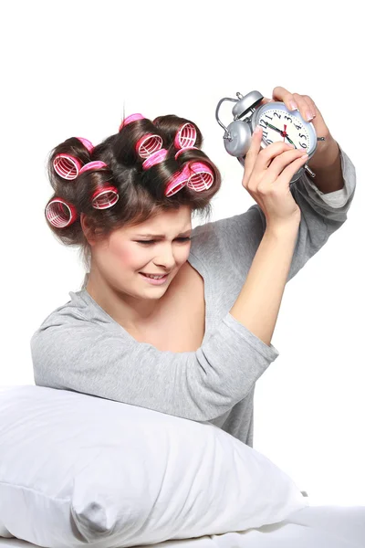 Happy positive young woman waking up and switching off the alarm clock — Stock Photo, Image