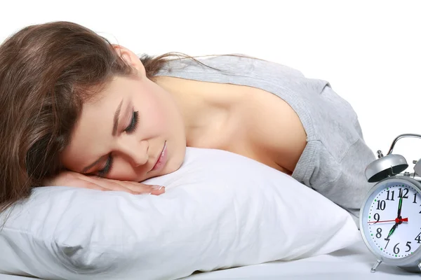 Happy positive young woman waking up and switching off the alarm clock — Stock Photo, Image