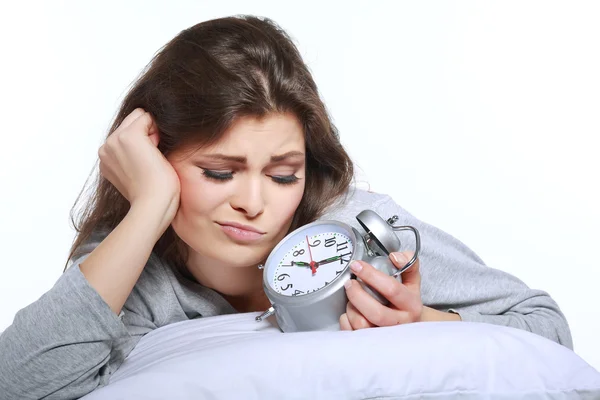 Happy positive young woman waking up and switching off the alarm clock — Stock Photo, Image