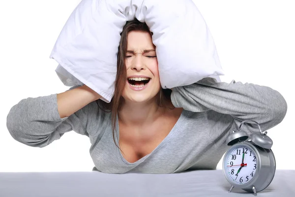 Happy positive young woman waking up and switching off the alarm clock — Stock Photo, Image