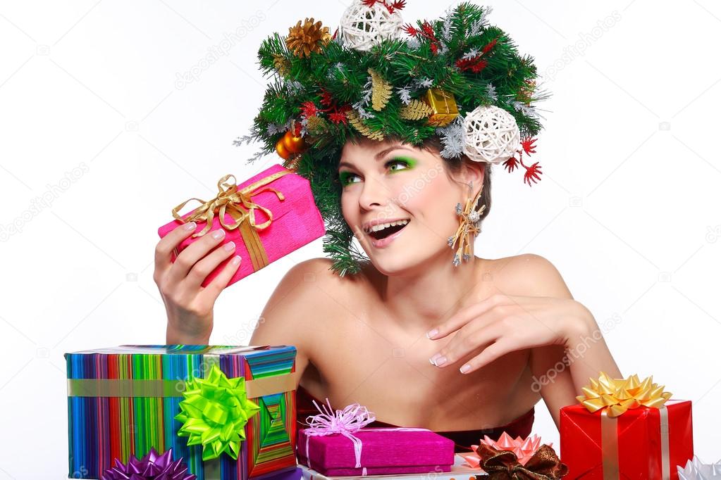 Christmas Woman. Beautiful New Year and Christmas Tree Holiday Hairstyle and Make up.