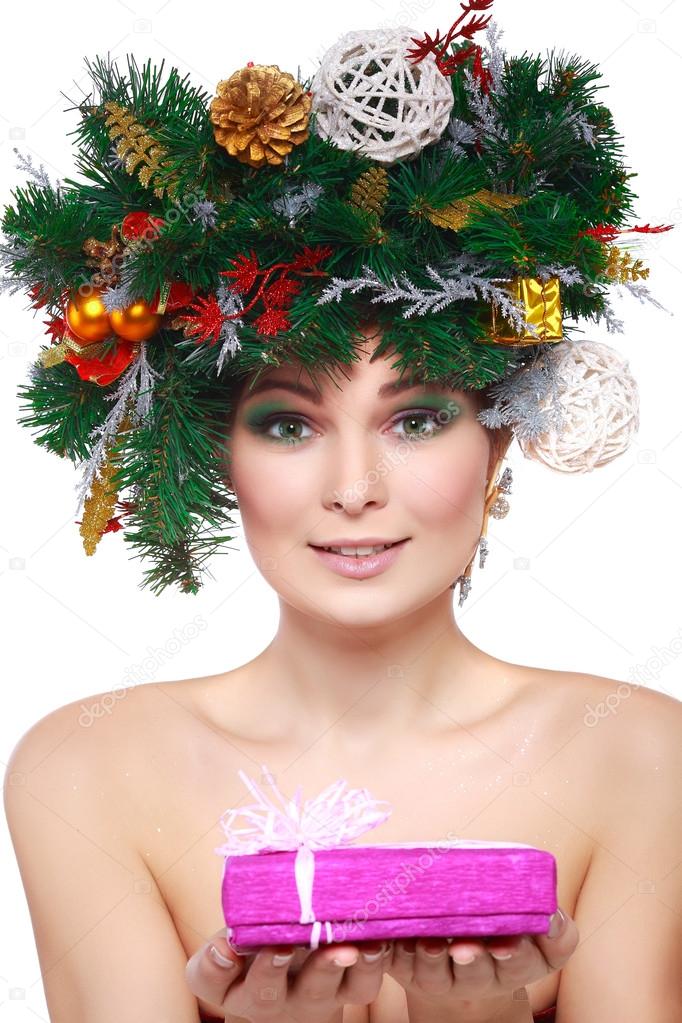 Christmas Woman. Beautiful New Year and Christmas Tree Holiday Hairstyle and Make up.