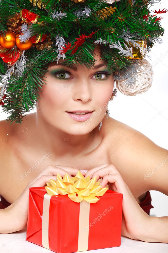 Christmas Woman. Beautiful New Year and Christmas Tree Holiday Hairstyle and Make up.