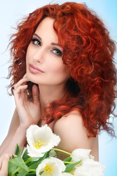 Beautiful young redheaded girl with white tulips — Stock Photo, Image