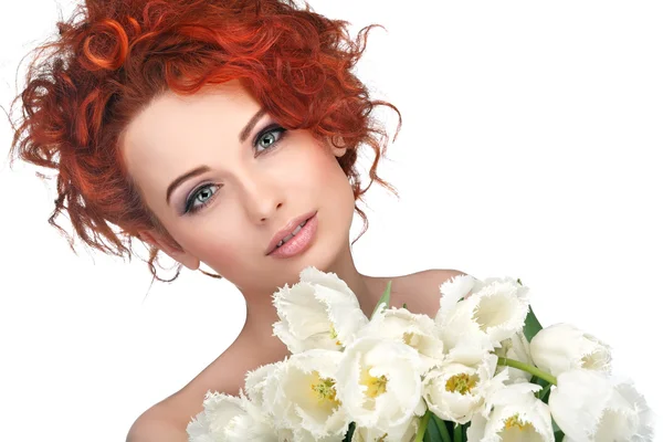 Beautiful young redheaded girl with white tulips, isolated on a white background — Stock Photo, Image