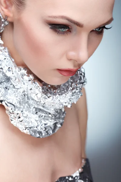 Beautiful girl with silver metallic foil on a neck, isolated on a light - grey  background, emotions, cosmetics — Stock Photo, Image