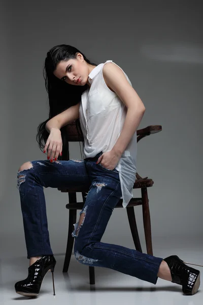 Photo of beautiful sexual brunette, sitting on a brown wooden chair, fashion style, glamour — Stock Photo, Image